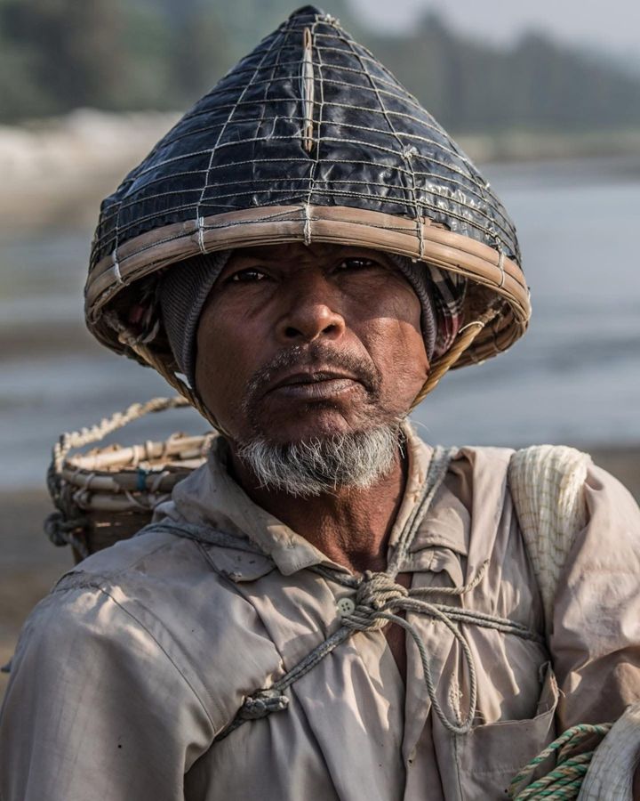 Fisherman, Bangladesh: an older man in a woven conical hat. Photograph by Marcus Vallance.